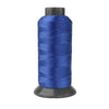 A spool of deep blue heavy-duty nylon sewing thread for upholstery and denim.