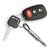 Black wall key holder with a silver key attached, featuring a red button and various key shapes.