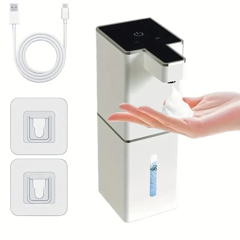 A white touchless automatic soap dispenser is shown with a hand dispensing soap and a bottle visible.