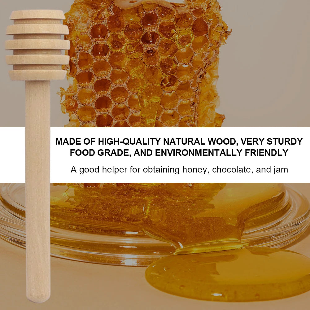 A wooden honey dipper stick next to golden honey and jam on a glass dish.