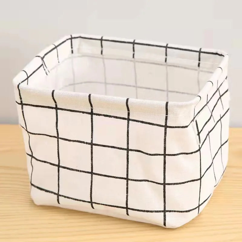 White cotton and linen storage basket with a black grid pattern