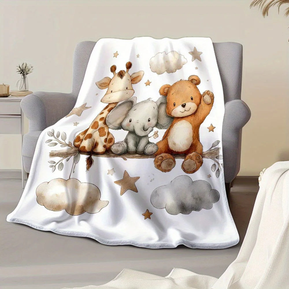 A white blanket featuring a print of a giraffe, an elephant, and a teddy bear against a light background.