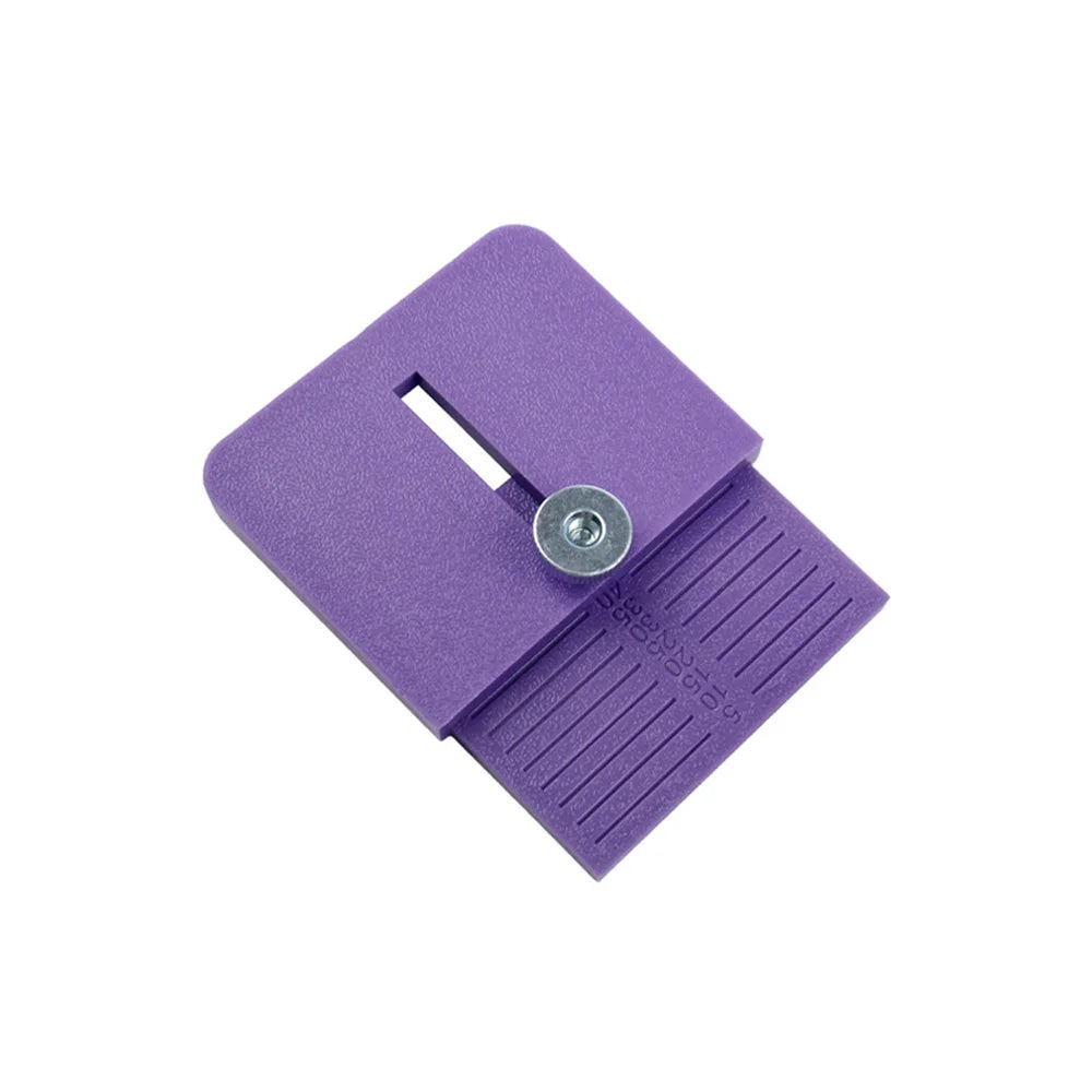 A purple precision vinyl cutting tool featuring a blade and a measurement scale on its surface.