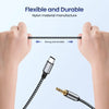 Hands demonstrate a flexible and durable nylon cable adapter connecting a USB-C to 3.5mm audio device.