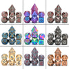 A set of seven metal polyhedral dice featuring a dragon font design in various colors and angles.