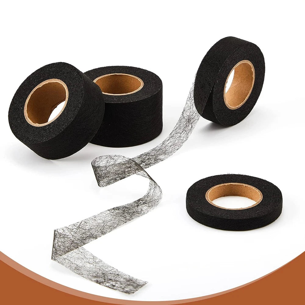 Rolls of black iron-on hemming tape for clothing repair shown on a white background.