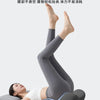 A person lying down with legs raised, wearing gray compression leggings, demonstrating the lightness of the leg muscle.