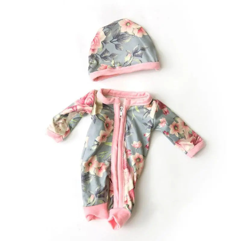 A floral patterned jumpsuit outfit for a baby doll, featuring a matching hat.