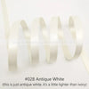 A roll of antique white satin ribbon shown in a wavy line against a white background.