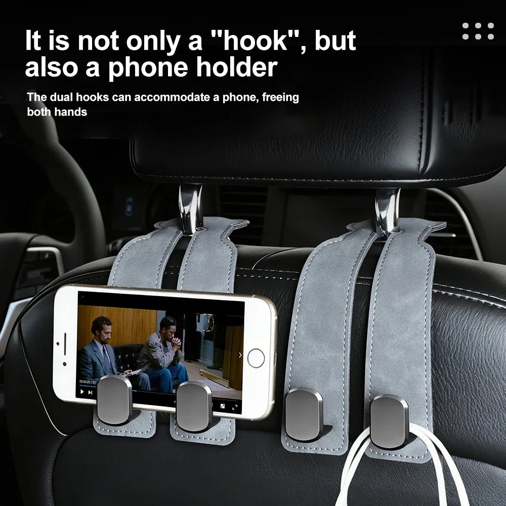 A dual hook phone holder is mounted on a car seat, showing its function for holding a smartphone.