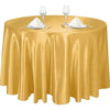 Elegant round satin gold tablecloth set with glassware and silverware for events