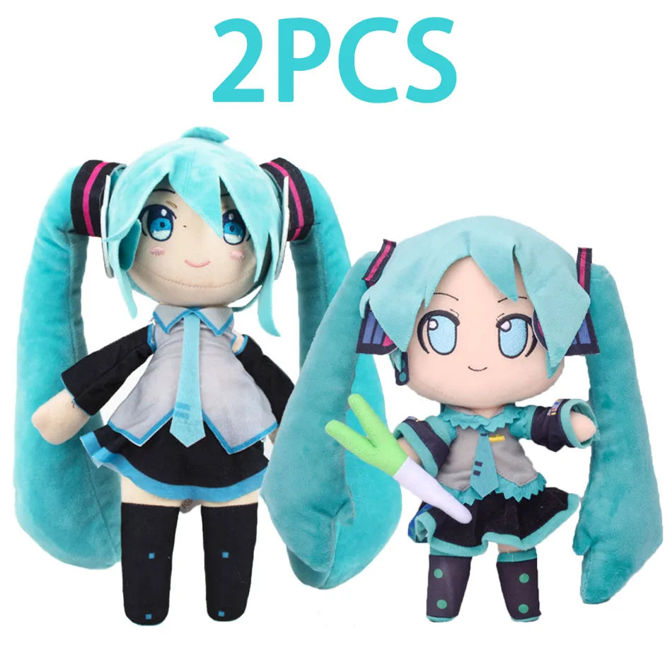 Two soft teal plush dolls of Hatsune Miku anime style figures with long hair and headphones