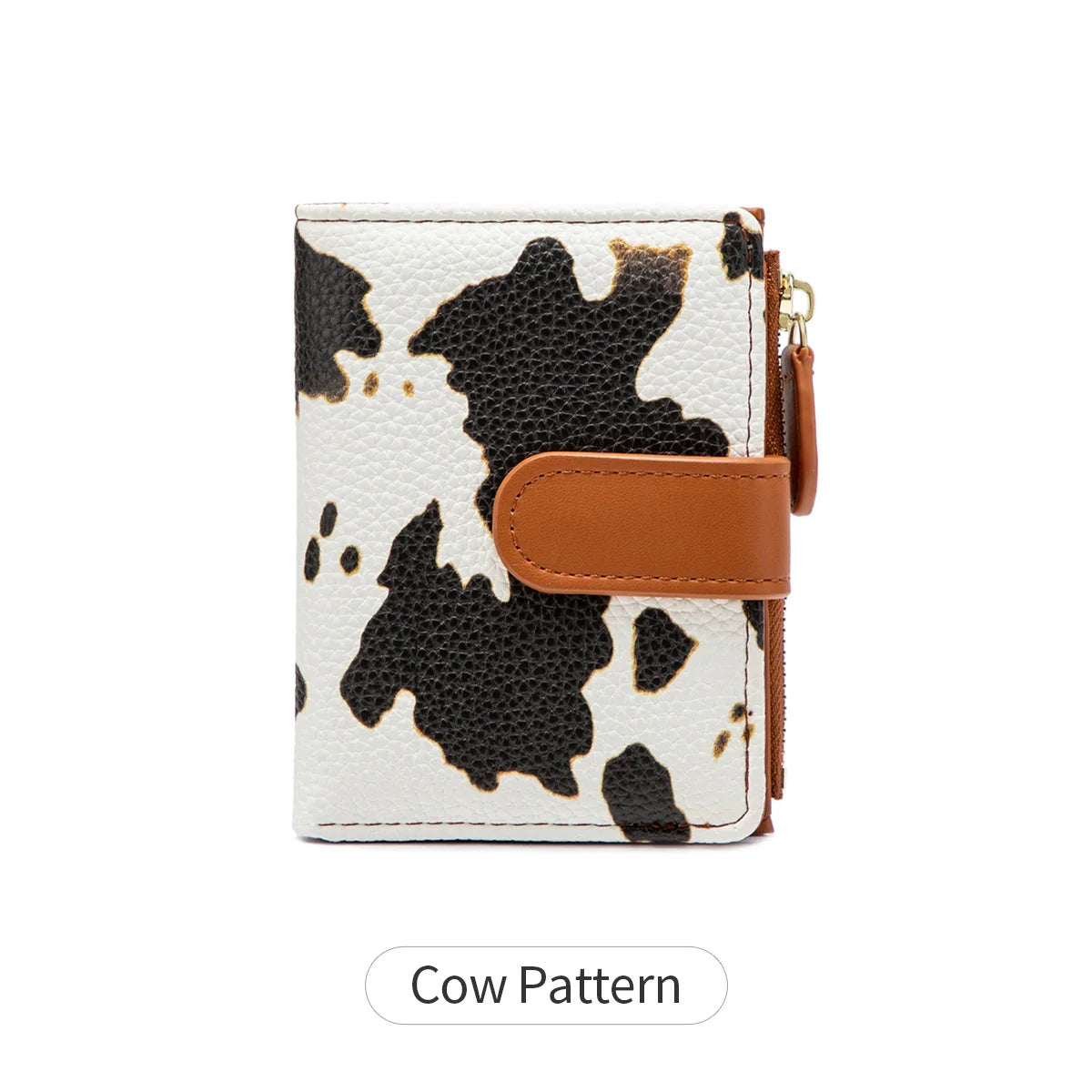 A white and black cow pattern bifold wallet made of croc-embossed PU leather with a brown leather strap.