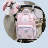 Pink bear print waterproof diaper backpack shown in detail with a close-up of the strap and main compartment.