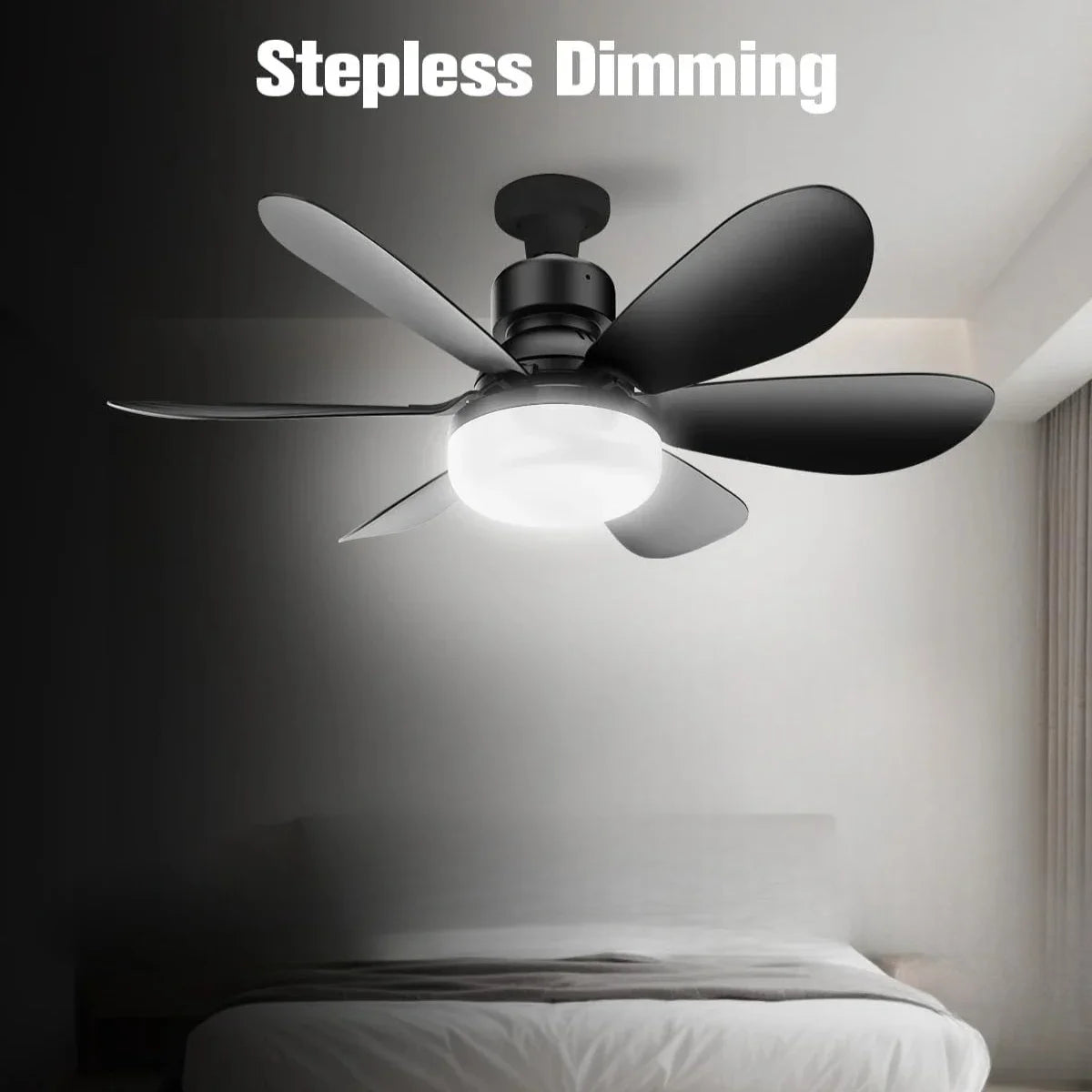 A black ceiling fan with a bright white light is mounted above a bed in a dimly lit room.