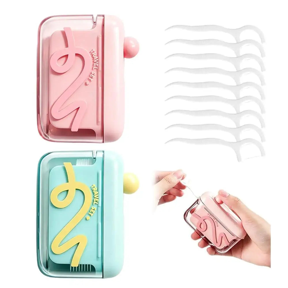 A pink and mint green portable automatic floss pick dispenser with a touchless pop-up mechanism and floss picks.