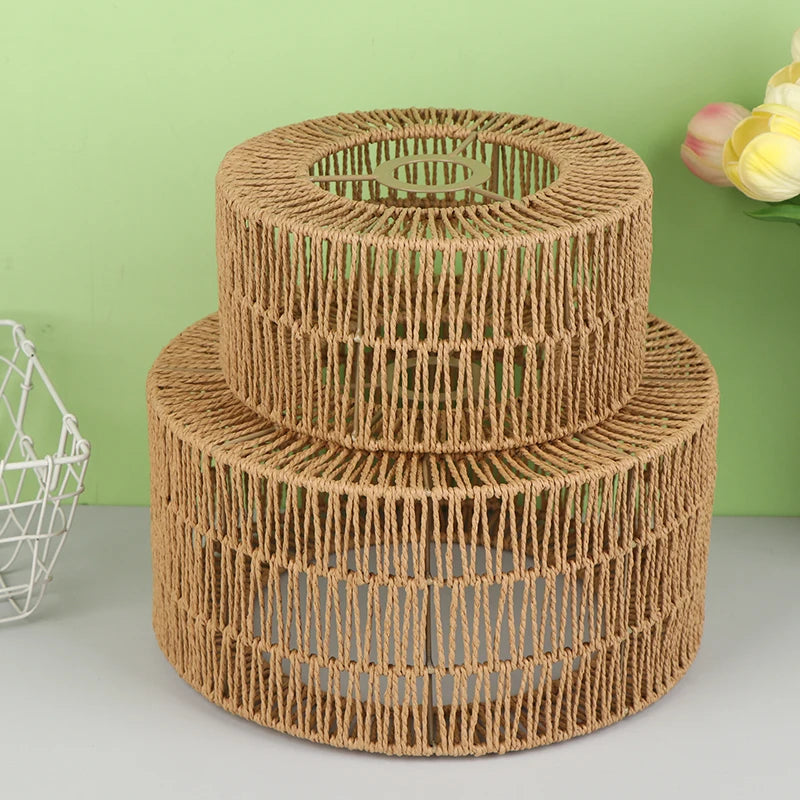 A cylindrical lampshade made of woven paper rope in a natural brown color.