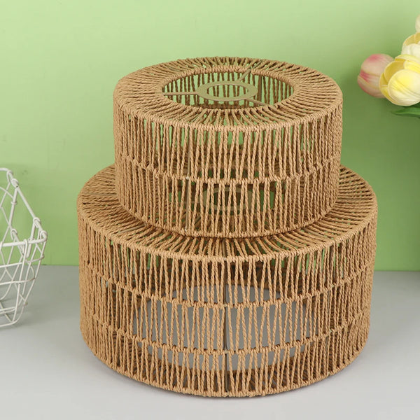 A cylindrical lampshade made of woven paper rope in a natural brown color.