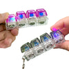 A hand holds several colorful LED light-up keyboard keychain fidget toys.