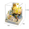 A miniature wooden dollhouse assembly kit featuring a garden scene with LED lighting and decorative elements.