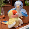 A fluffy blue and white plush parrot toy with an orange beak sits next to a yellow and white plush bird.