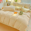 A beige floral duvet cover set with a matching flat sheet and pillows displayed on a bed.