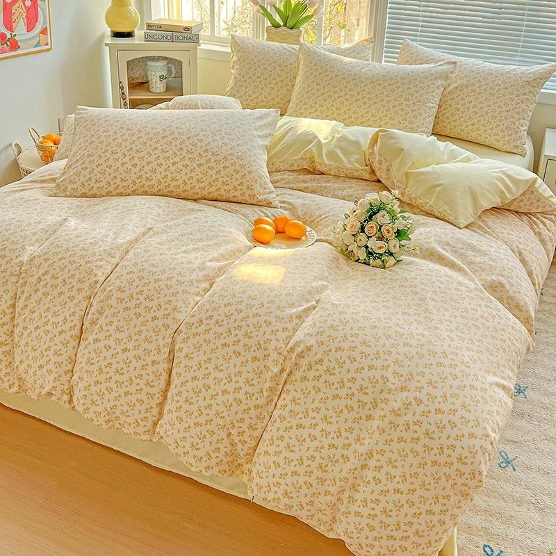 A beige floral duvet cover set with a matching flat sheet and pillows displayed on a bed.