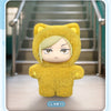 A yellow cat-eared plush doll with a hood and pale skin, displayed in a vertical box format.