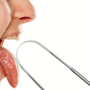A stainless steel tongue scraper is shown next to a person's mouth, used for cleaning the tongue.