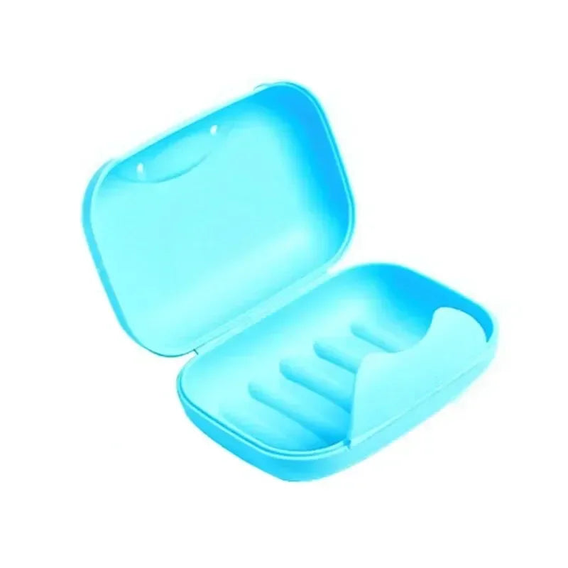 A light blue portable soap holder with a lid, designed as a leak-proof travel case for bathroom and shower use.