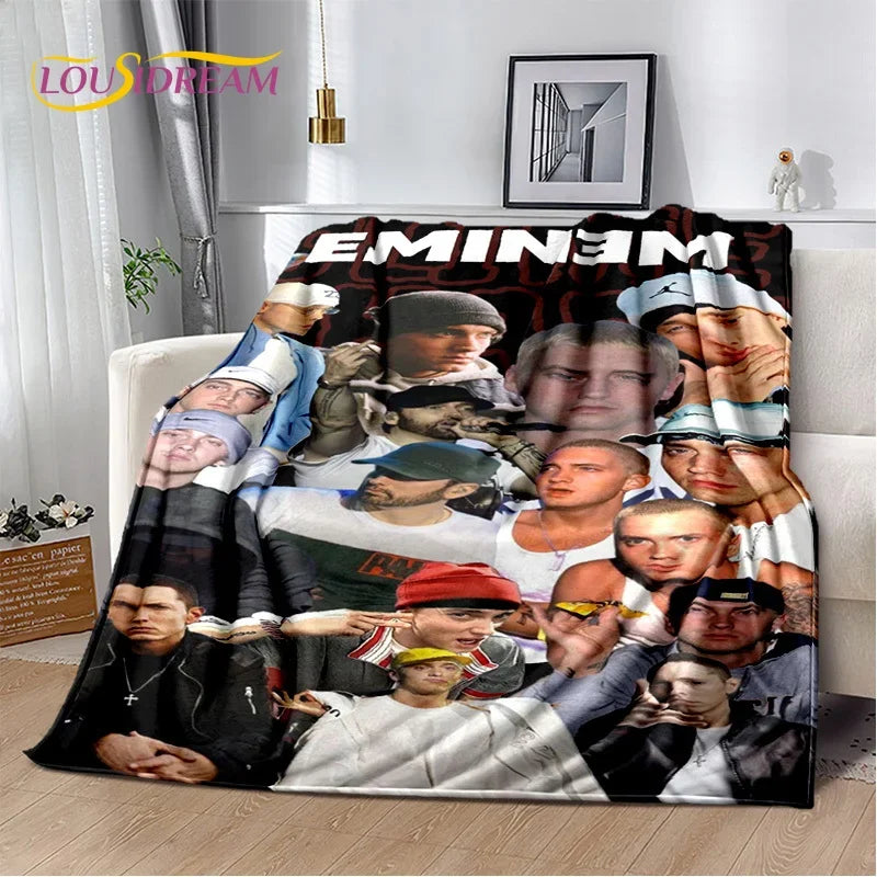 A throw blanket featuring portraits of Eminem and 2Pac hip-hop icons.