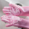 A pair of pink scrubber-textured dishwashing gloves are shown in a close-up against a white sink.