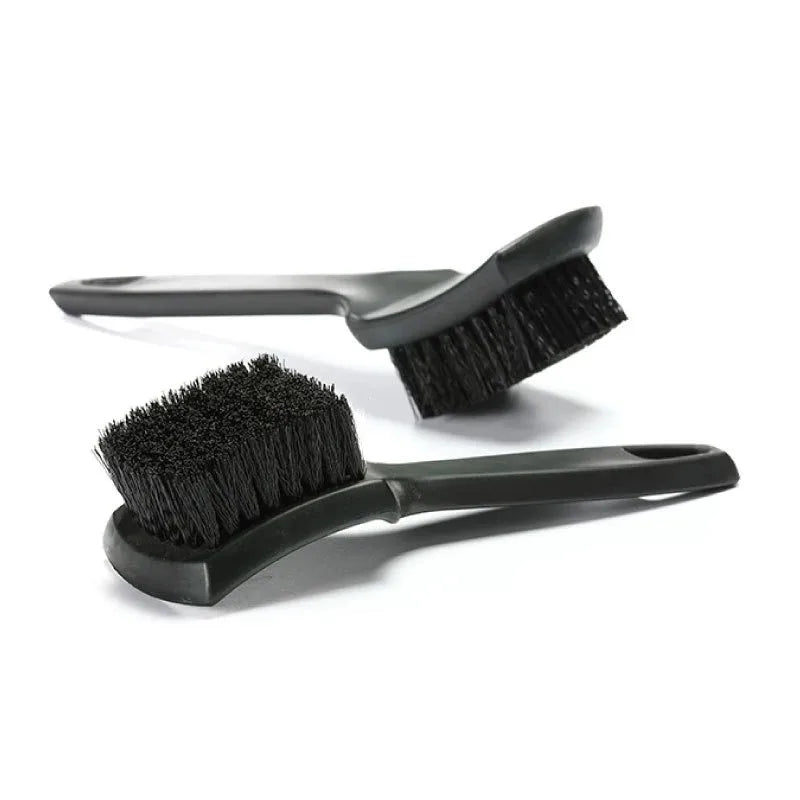 A black heavy-duty tire and wheel cleaning brush set with a handle and bristles.