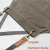 A gray cotton canvas apron featuring hardware buckles and cross-back straps.
