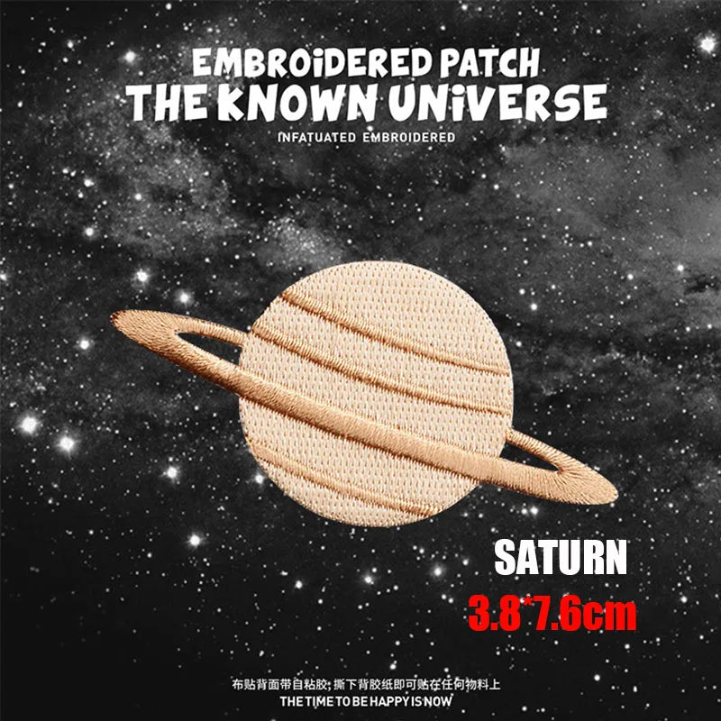 Embroidered patch of Saturn in a golden color against a dark space background