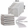 A stack of white double-layer microfiber cleaning cloths for kitchen use.