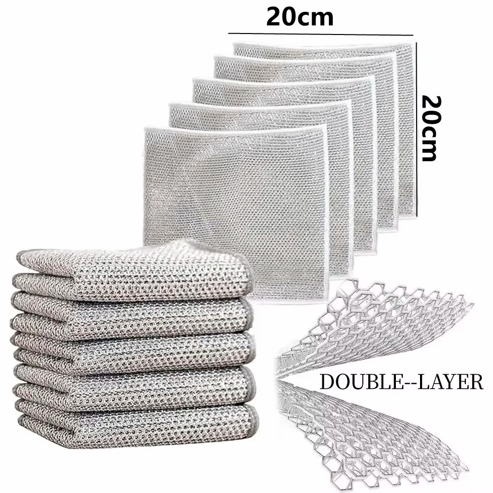 A stack of white double-layer microfiber cleaning cloths for kitchen use.