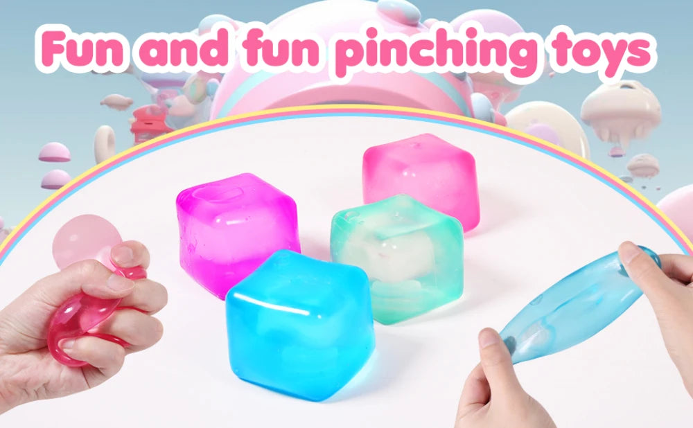 Hands are squeezing four colorful squishy stress cubes including pink, green, and blue varieties on a white surface.