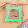 A rectangular switch cover frame with an elegant rose pattern border and a bright green background, measuring 15.5cm by 8.6cm