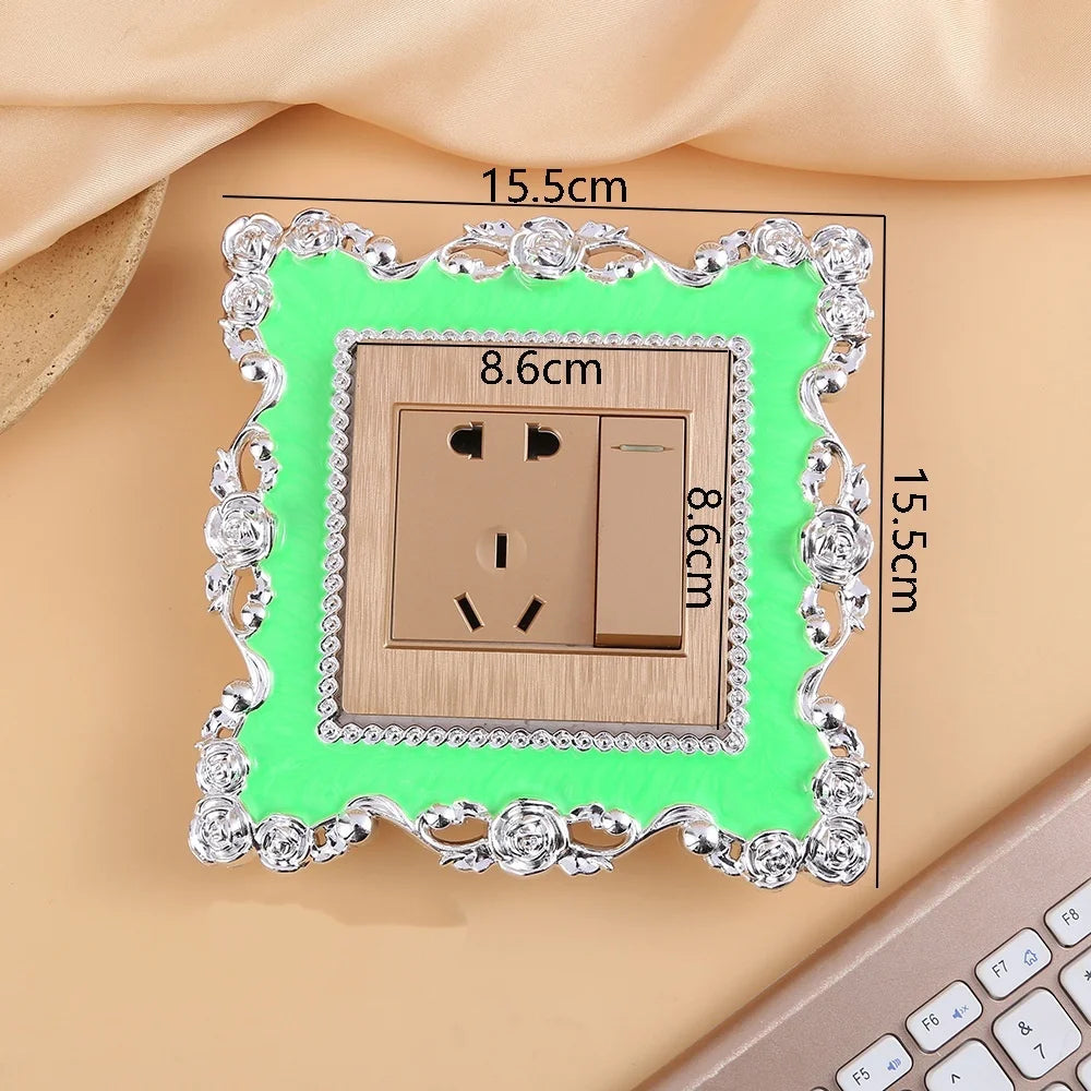 A rectangular switch cover frame with an elegant rose pattern border and a bright green background, measuring 15.5cm by 8.6cm