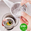 A hand is holding a disposable mesh sink strainer bag filled with food, demonstrating the product.