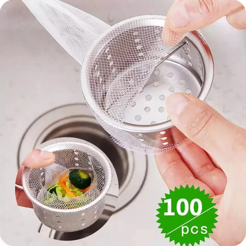 A hand is holding a disposable mesh sink strainer bag filled with food, demonstrating the product.