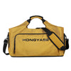A mustard yellow duffel bag with black straps and a shoe pocket visible from the front.