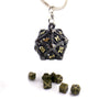 A single black metal die with gold numbering hangs from a silver loop, alongside several loose dice.