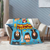 A colorful cartoon-themed throw blanket featuring characters from Bob's Burgers draped over a beige sofa.