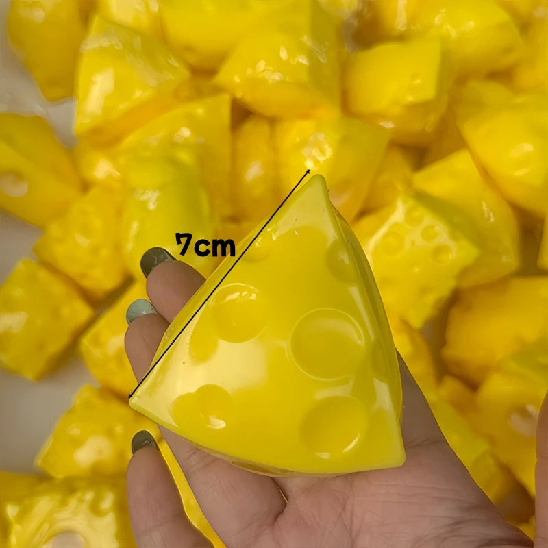 A hand holds a yellow, triangular fidget cube with dimples against a background of similar yellow pieces.