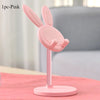 A pink rabbit-shaped stand for a mobile phone or tablet, featuring long ears and a flat base.