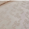 White linen duvet cover featuring a delicate white embroidered leaf pattern.