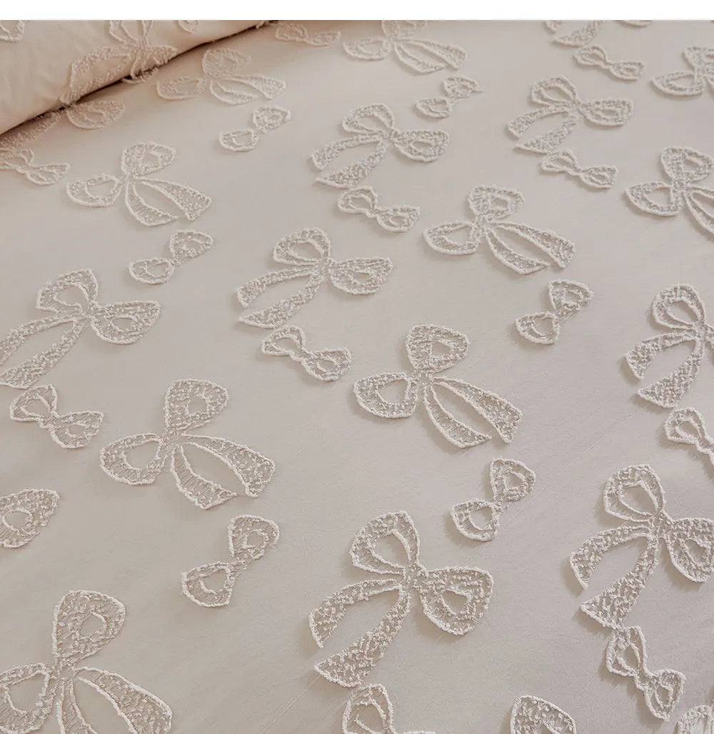 White linen duvet cover featuring a delicate white embroidered leaf pattern.