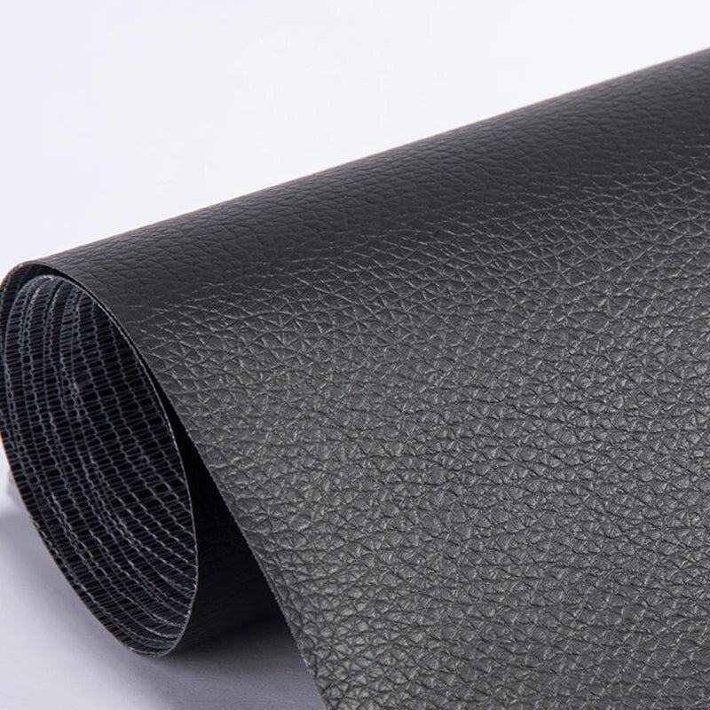 Roll of black self-adhesive PU leather repair patches, showing the textured surface.
